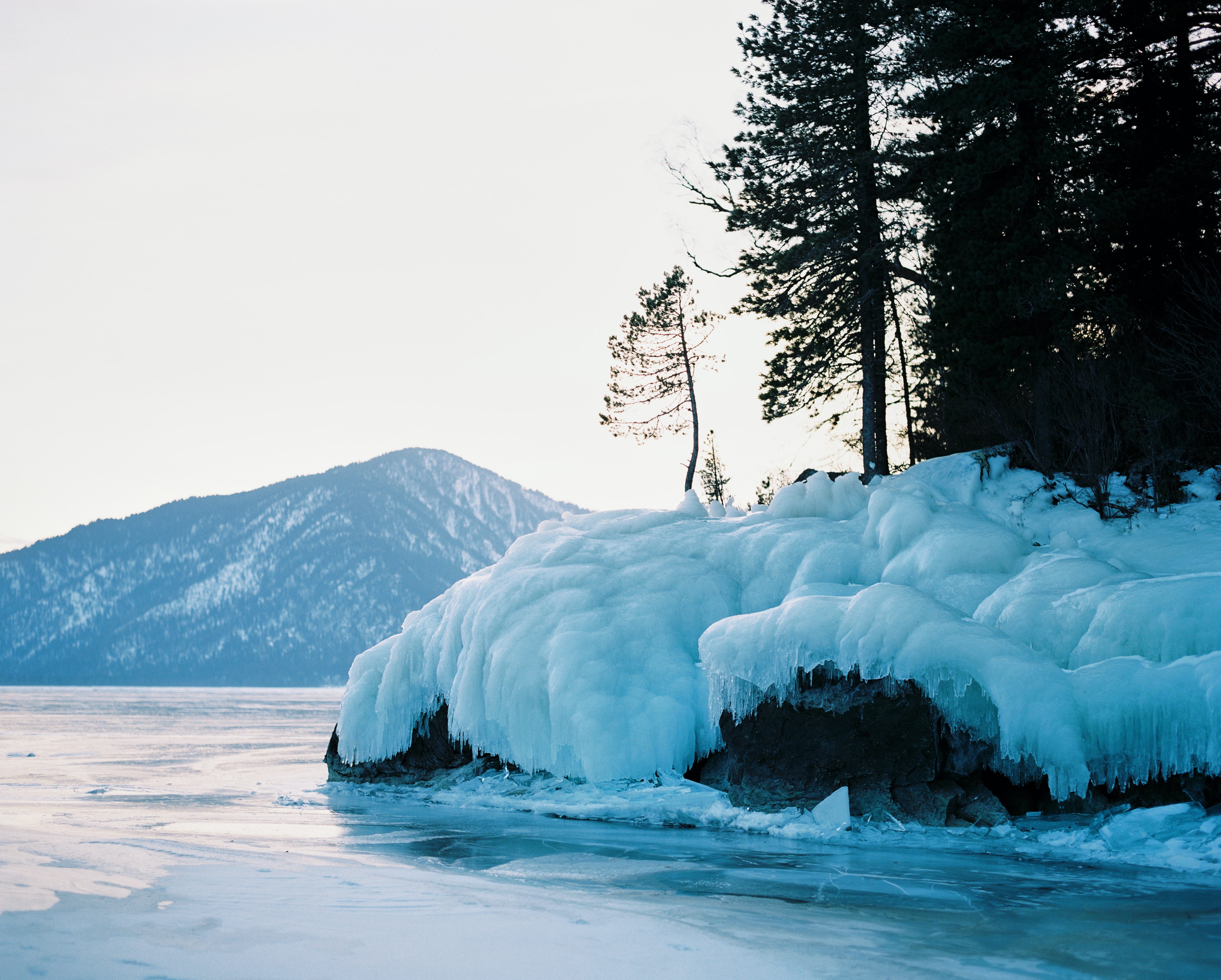 a hill and lake in wintertime